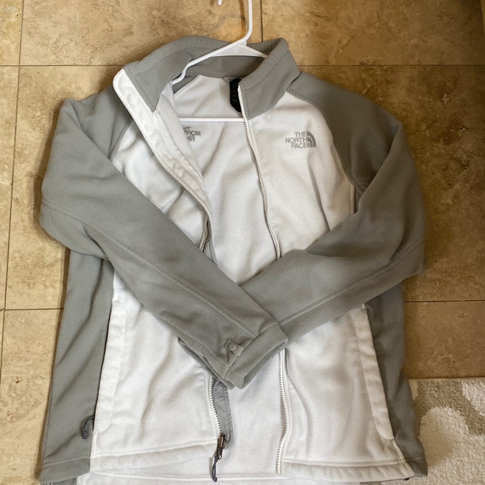 White and gray north face fleece jacket